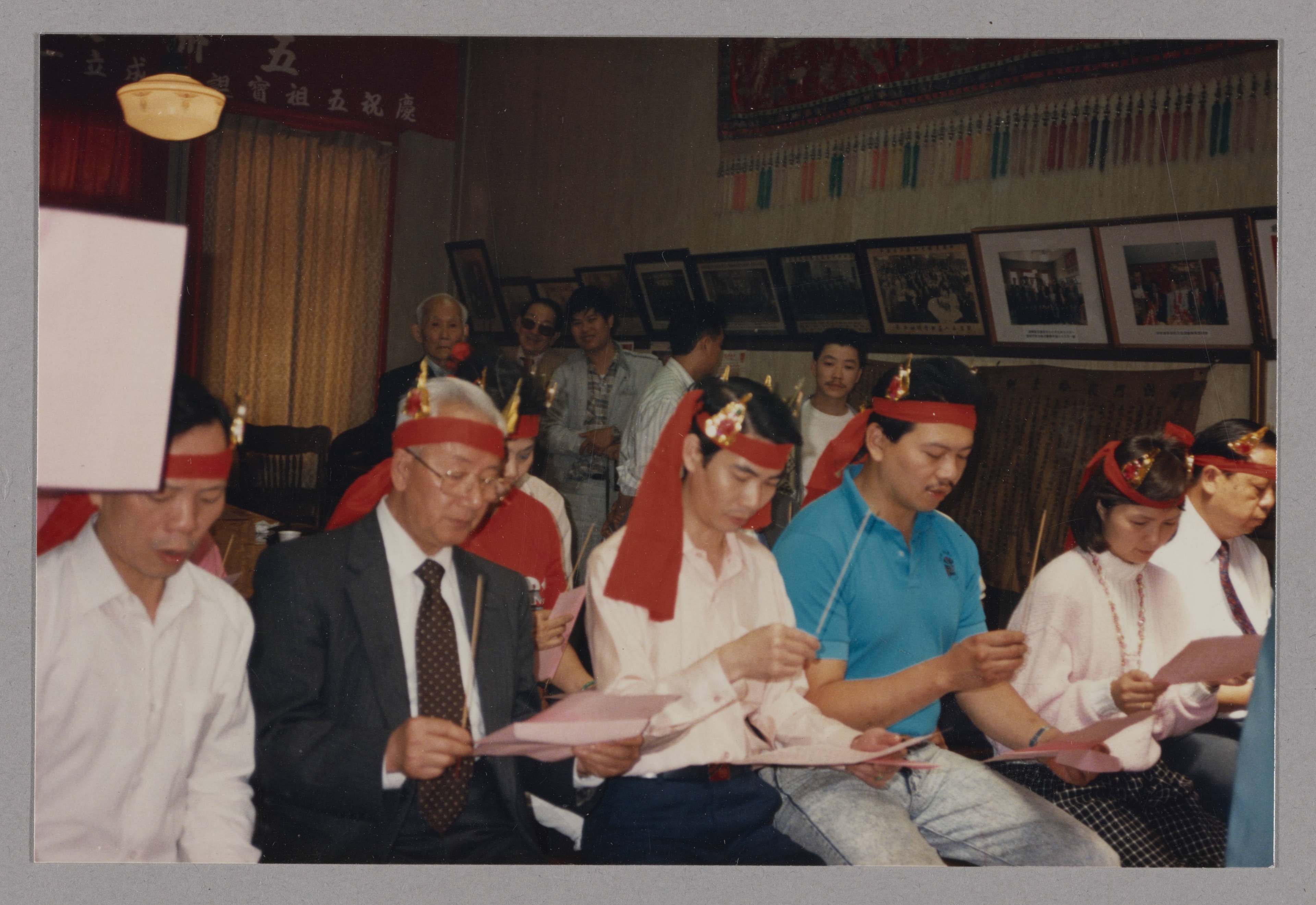 Spring celebration and Five Ancestors observance (五洲洪門致公總堂春宴聯歡・慶祝五祖寶誕). Participants wearing ceremonial headbands and holding incense.