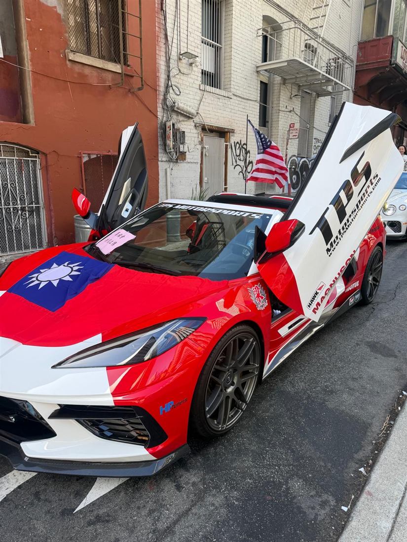 Red and white celebration car displaying a Republic of China flag on Spofford Street