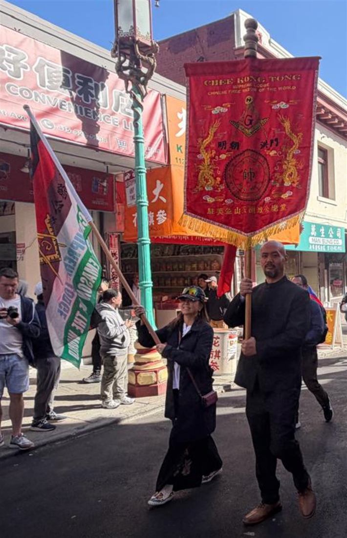 Participants carrying the Chee Kung Tong flag and embroidered red Supreme Lodge banner